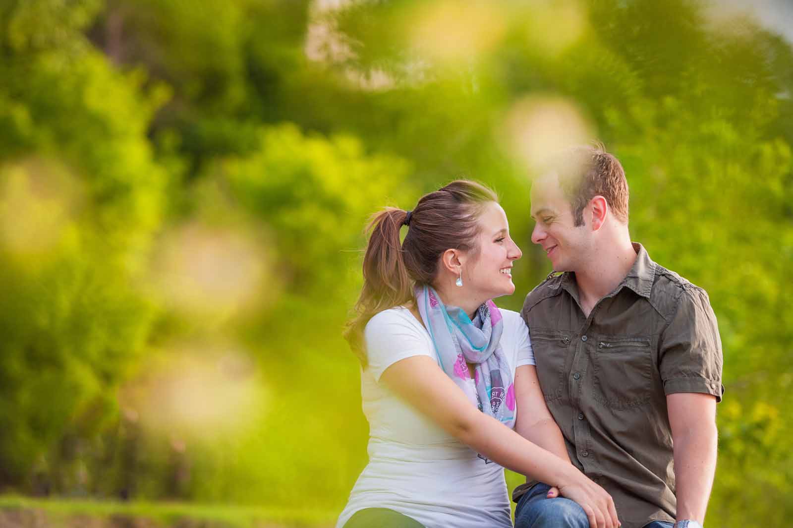 An engaged couple looking at each other with love in the summer for their Ottawa engagement session