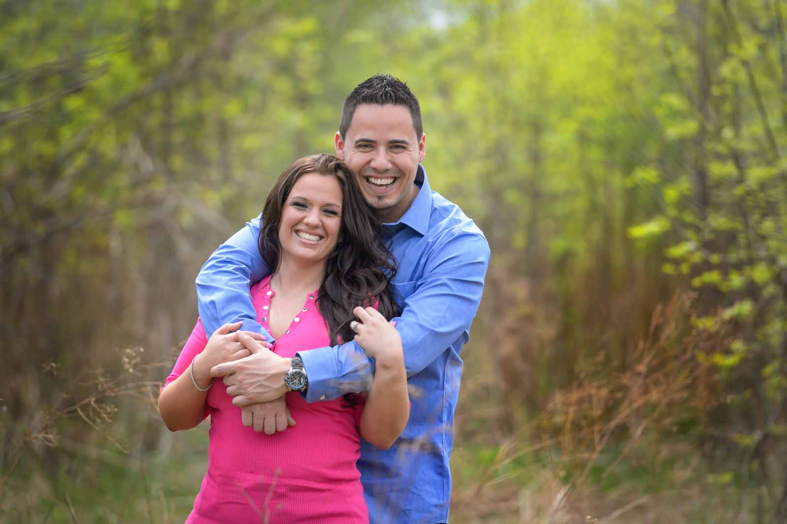 A classic portrait of the couple looking at the camera smiling at their engagement session in Manotick, Ottawa, Ontario