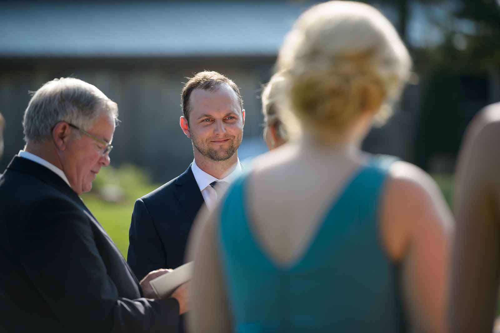 Soon to be husband looking at his fiancé with lots of emotions in his yes, at a beautifu, sunny outdoor wedding in Ottawa