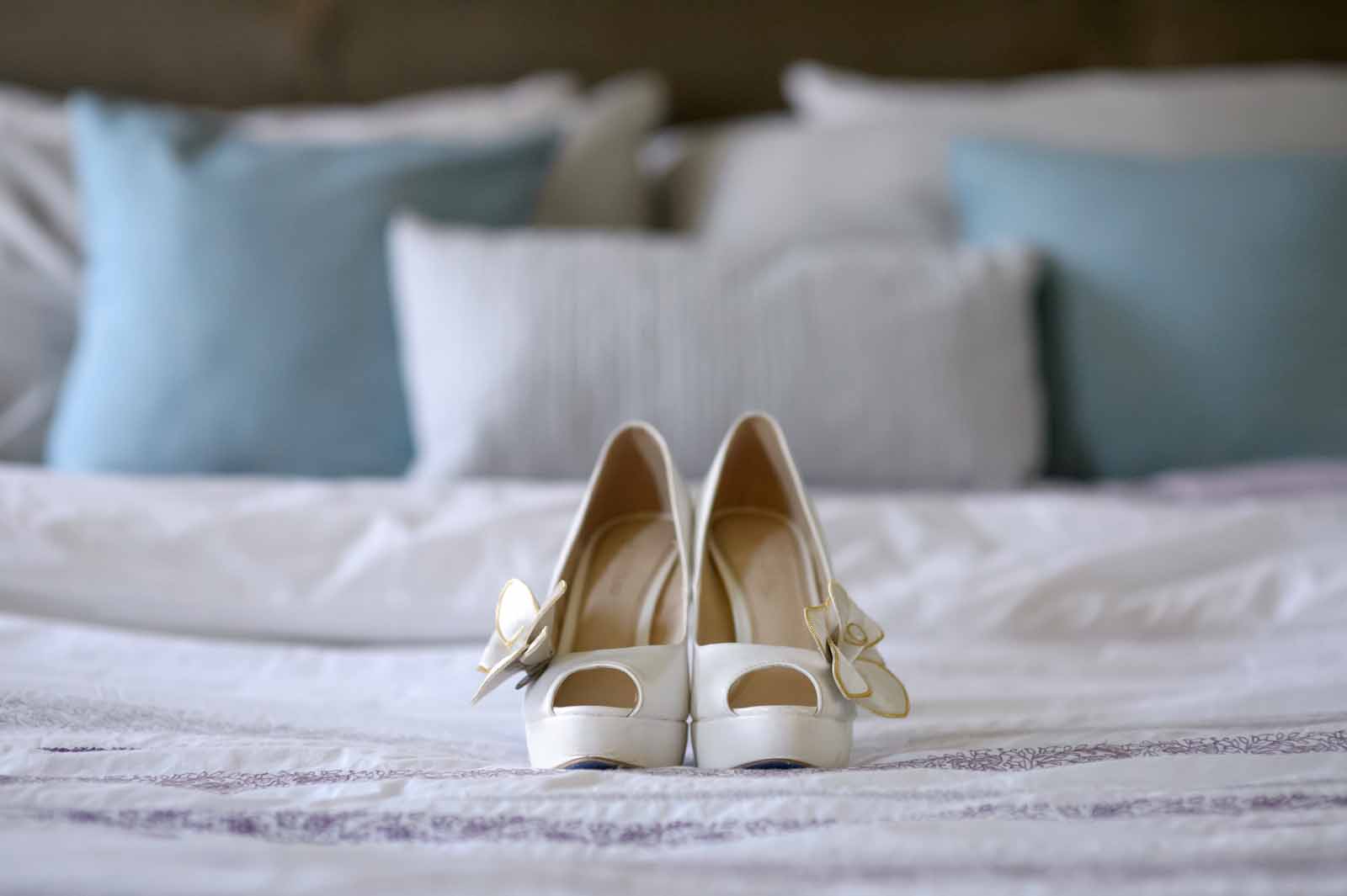 Bride Wedding shoes sitting on a bed