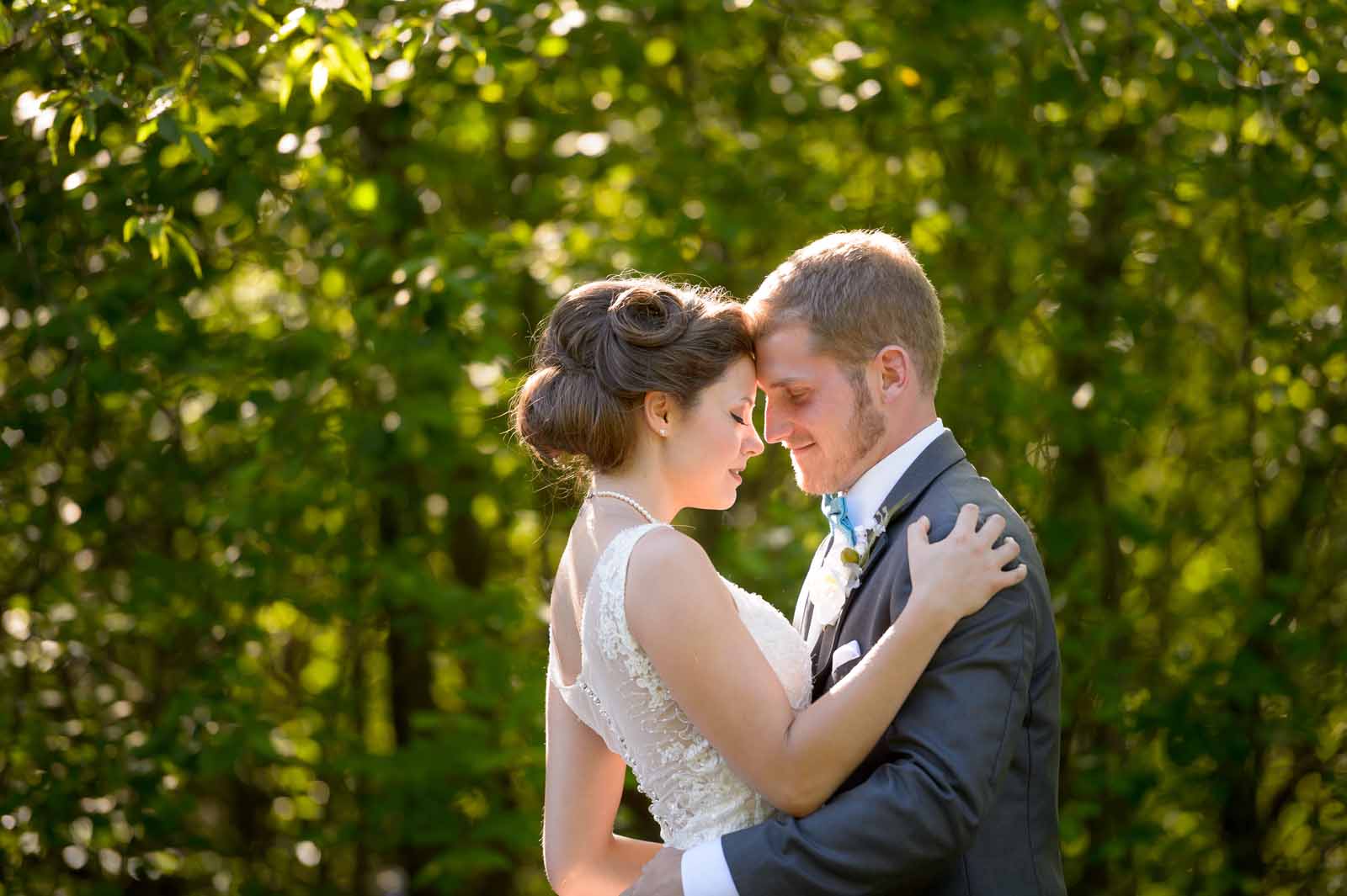 Bride and groom in a romantic embrace at Mer Bleu in Ottawa