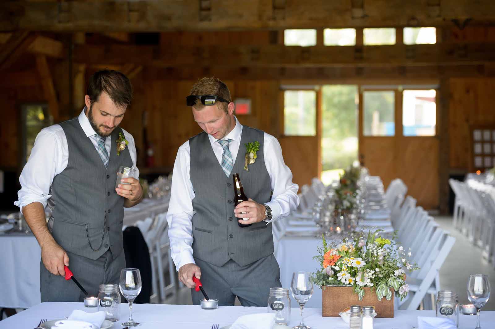 Groomsmen having a beer while doing last minute setup on the decor of the wedding reception