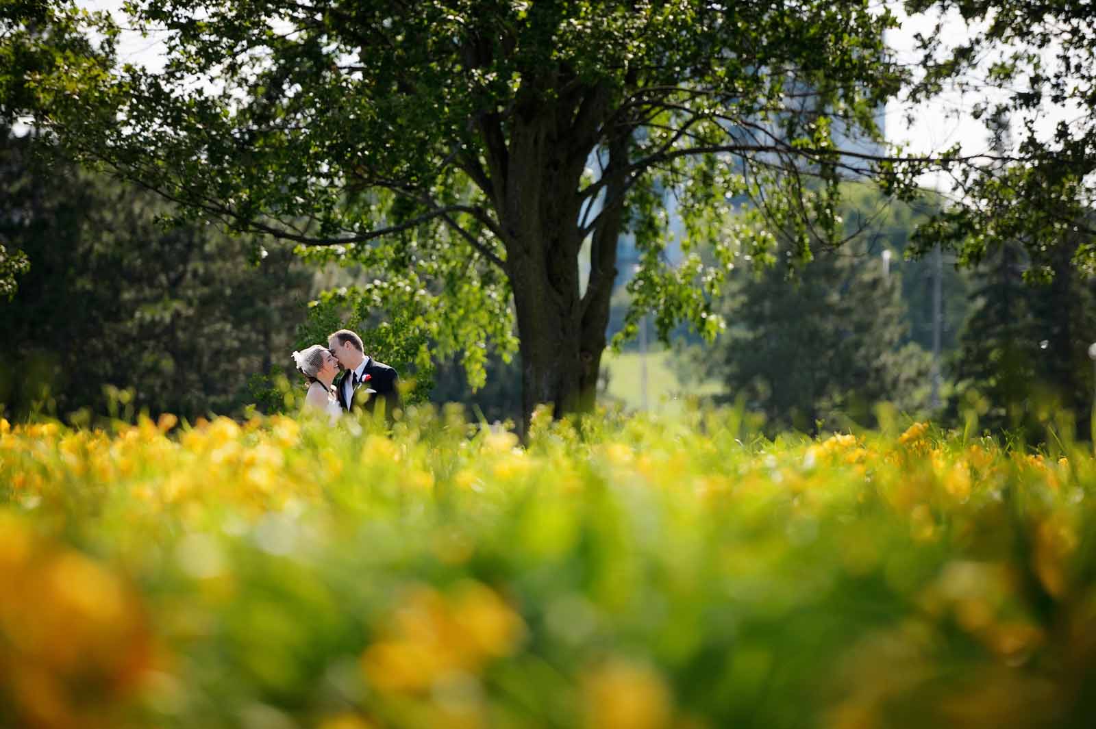Groom giving the bride a kiss on her cheek on their wedding day at the Museum of Science and Technology