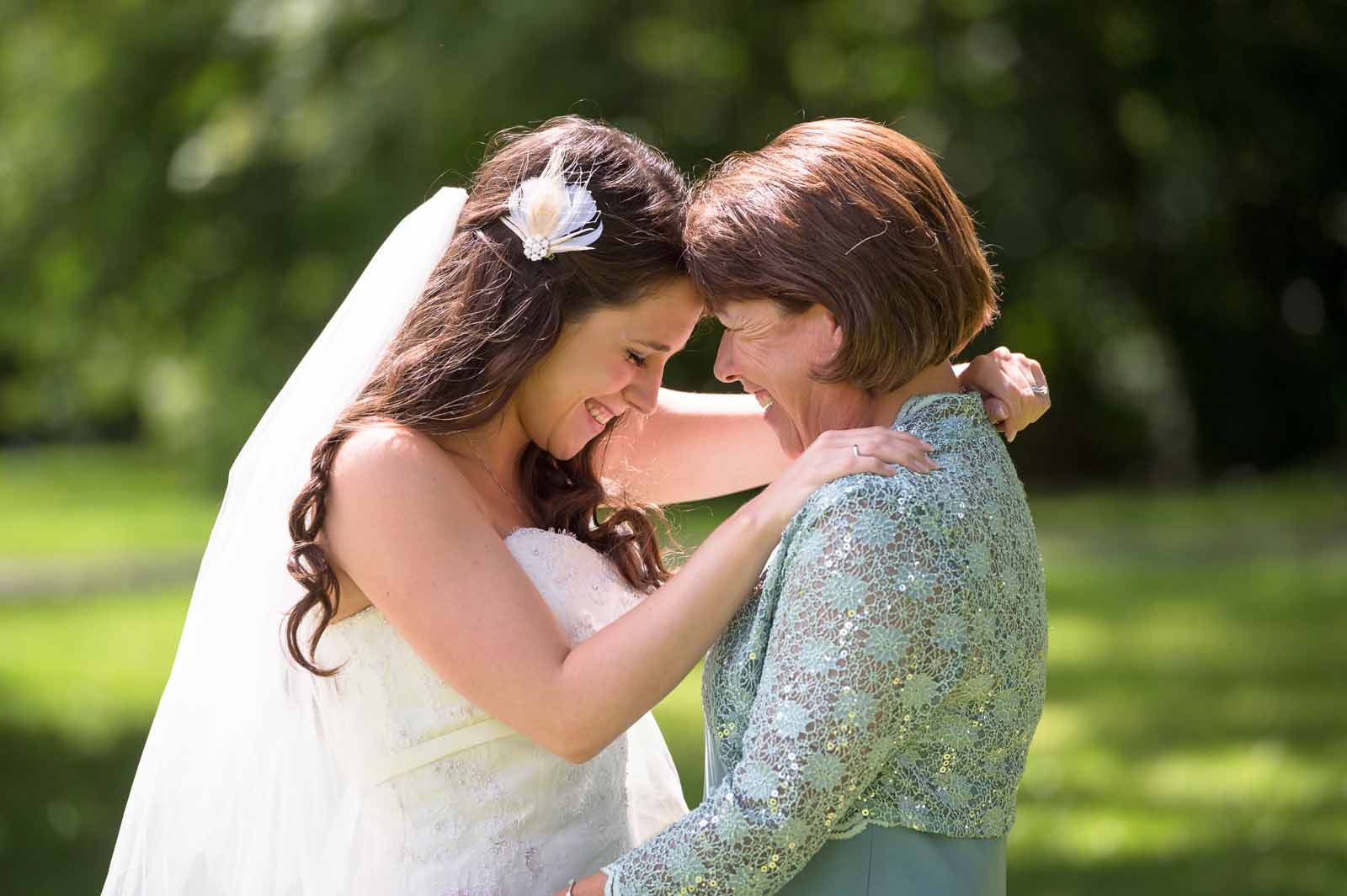 A bride sharing a special and emotional moment with her Mom on her wedding day